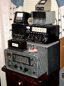 Hammarlund HX-50 Transmitter, Drake 2B/2BQ receiver/q-multiplier, Hallicrafters TO keyer, Vibroplex paddle, Pennwood Numechron Tymeter, B&W SWR meter and Turner microphone.